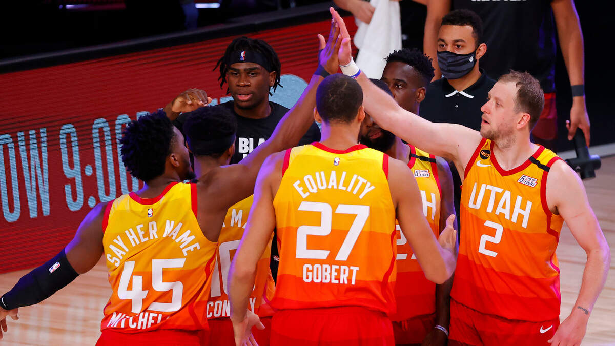 Members of the Utah Jazz celebrate a win against the Denver Nuggets in Game 4 of an NBA basketball first-round playoff series, Sunday, Aug. 23, 2020, in Lake Buena Vista, Fla. (Kevin C. Cox/Pool Photo via AP)