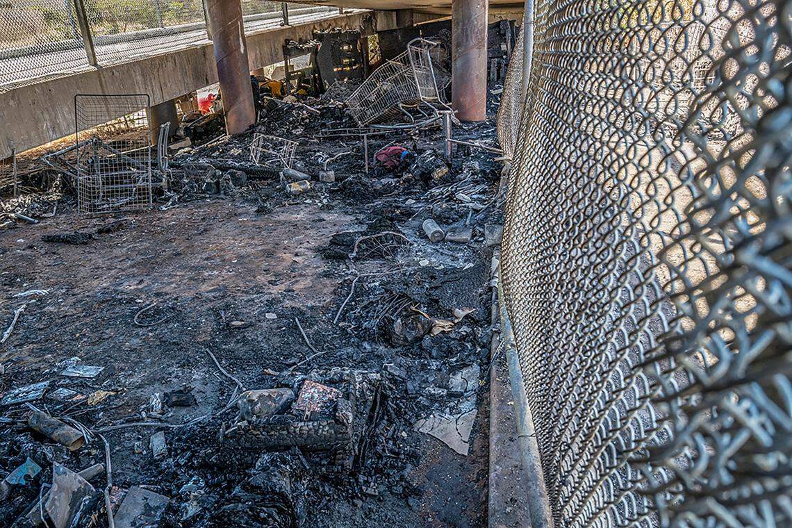 The charred belongings of homeless campers remain under a pedestrian bridge that spans Highway 99 north of Elk Grove Boulevard. The city closed the bridge for a few days until inspectors determined that it was safe to reopen.