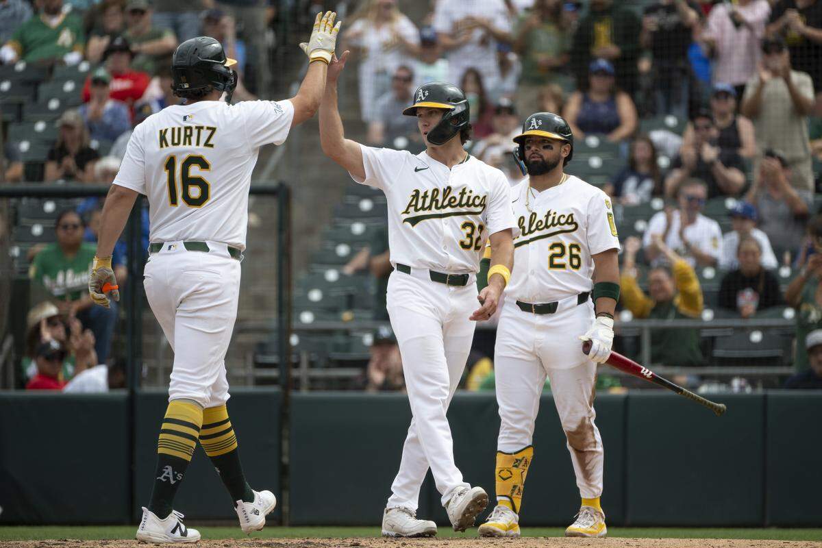 Athletics first base Nick Kurtz (16) and Athletics outfielder Colby Thomas (32) high five after Kurtz’s home run during a game between the Athletics and the Kansas City Royals at Sutter Health Park in West Sacramento on Sunday, Sept. 28, 2025.