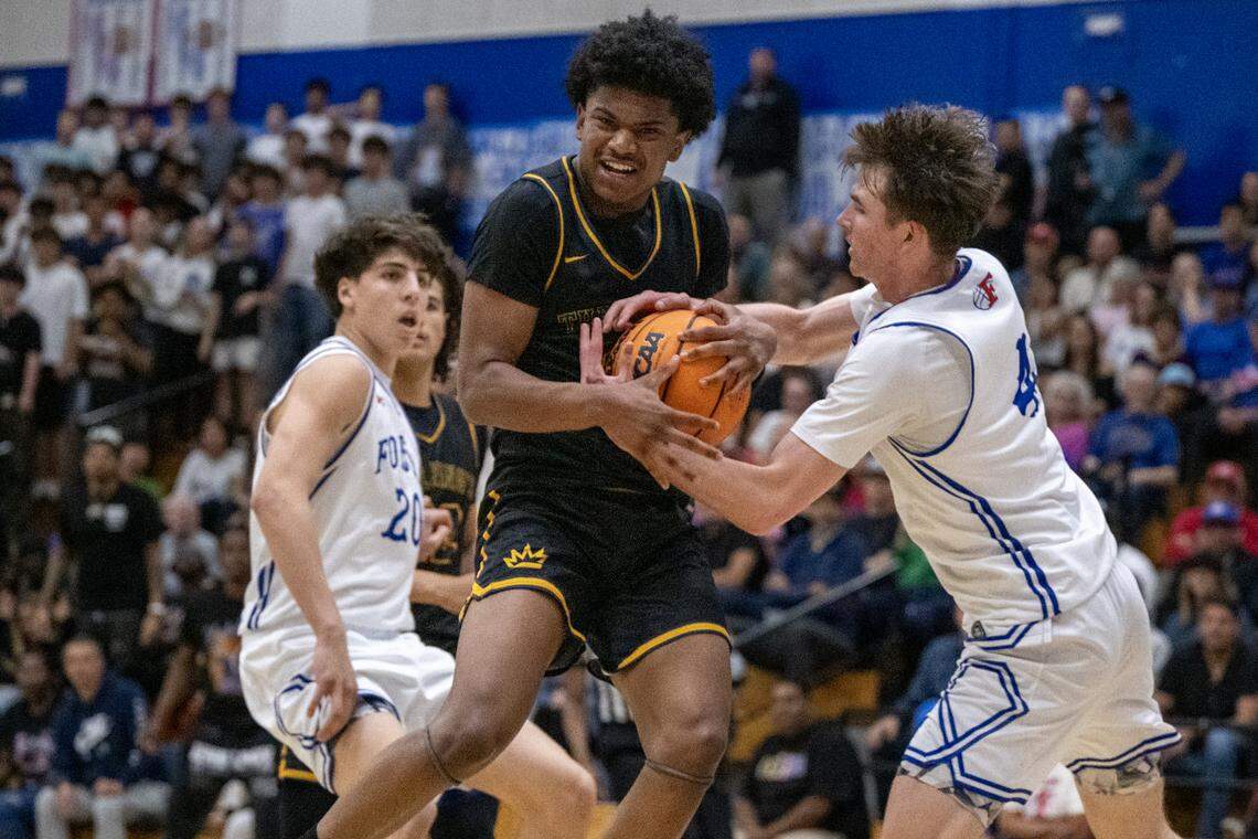 The Folsom Bulldogs' Jack Shull strips the ball from the Kings Academy Knights' Adrian Barnett in the second half in the CIF Northern California Regional Division I boys basketball championship on Tuesday in Folsom.