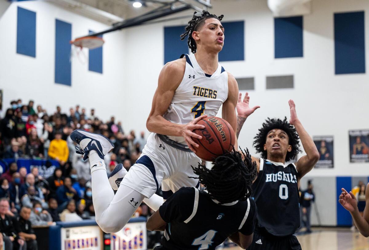 Inderkum Tigers’ Jalen Glenn (4) charges in the air at Sheldon Huskies’ Rashaud Bradley (4) during the second period at the high school boys basketball Sac-Joaquin Section Division I semifinal playoff game Wednesday, Feb. 23, 2022, at Inderkum High School in Sacramento. Sheldon beat Inderkum, 85-80, to advance to the title game.