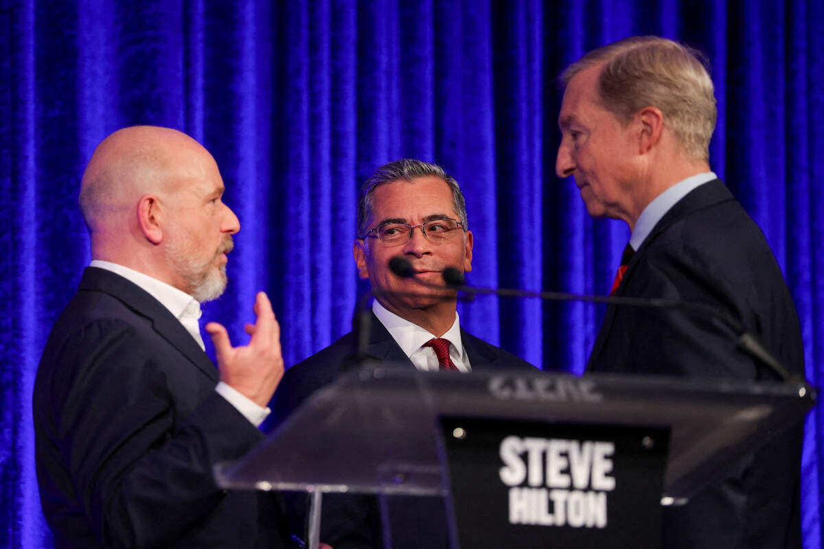 Candidates Steve Hilton, Xavier Becerra and Tom Steyer talk at the end of a debate in the race for governor of California, in San Francisco on May 14, 2026.