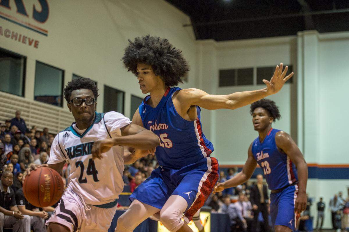 Sheldon Huskies forward Ronald Agebsar (24) drives past Folsom Bulldog Mason Forbes (25) in the third quarter as the Huskies beat Folsom 64-56 in the boys NorCal Open semifinal at Cosumnes River College on Tuesday, March 13, 2018.