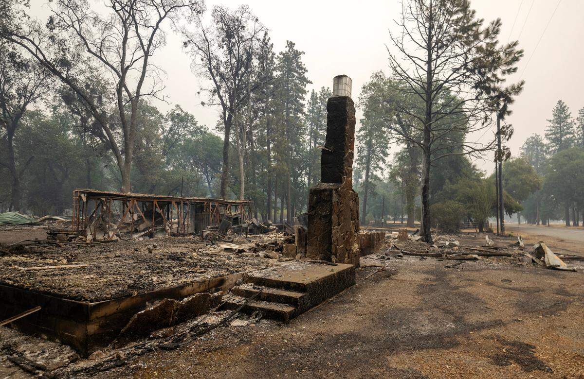 A chimney stands on Saturday amid the remains of a farmhouse burned in the Park Fire near Paynes Creek on Highway 36.