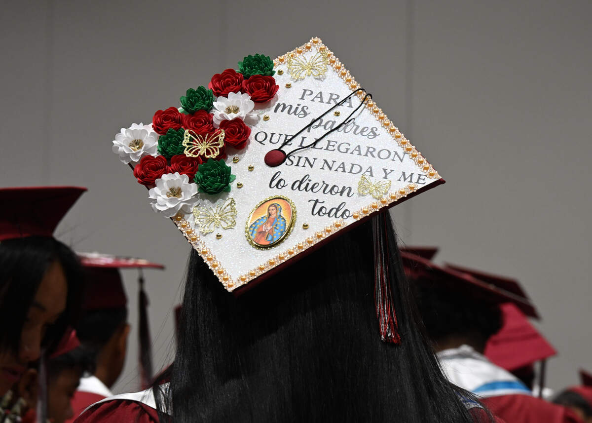 A student’s mortarboard reads in Spanish “For my parents who came with nothing and gave me everything” at the Hiram Johnson High School graduation on Wednesday.
