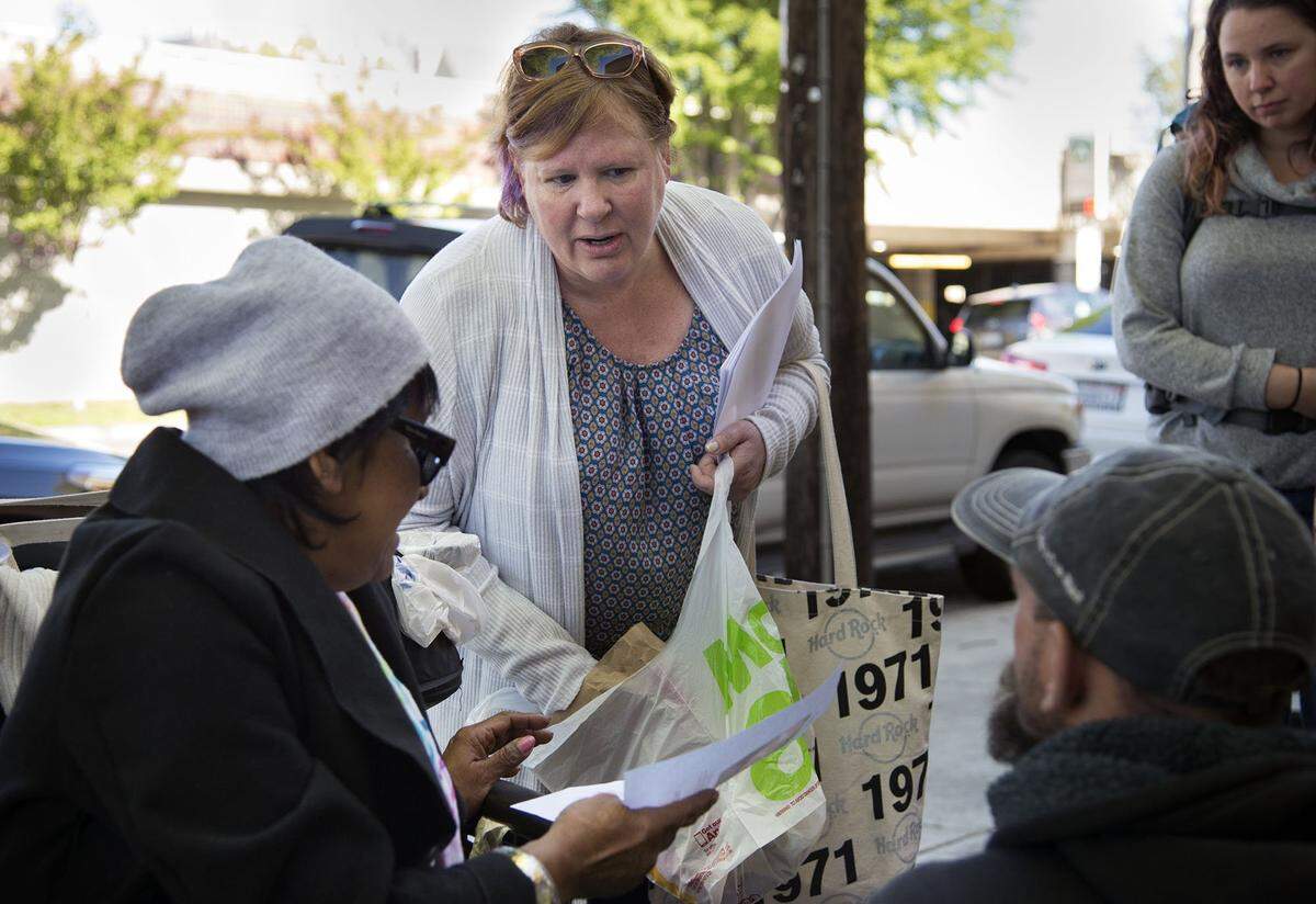 Margaret Wener hands out fliers and food on Friday to a homeless group near 30th and K streets in hopes of getting information regarding her mentally disabled son, Michael Fristoe. After being missing for 12 days, Fristoe was found safe Saturday in the Arden Arcade area.