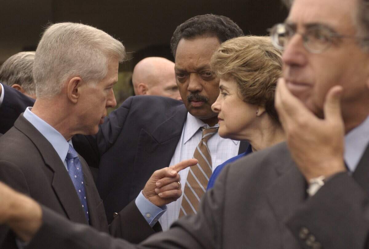 Gov. Gray Davis speaks with Rev. Jesse Jackson, center, and Sen. Dianne Feinstein as he campaigns against the recall effort on Oct. 4, 2003.