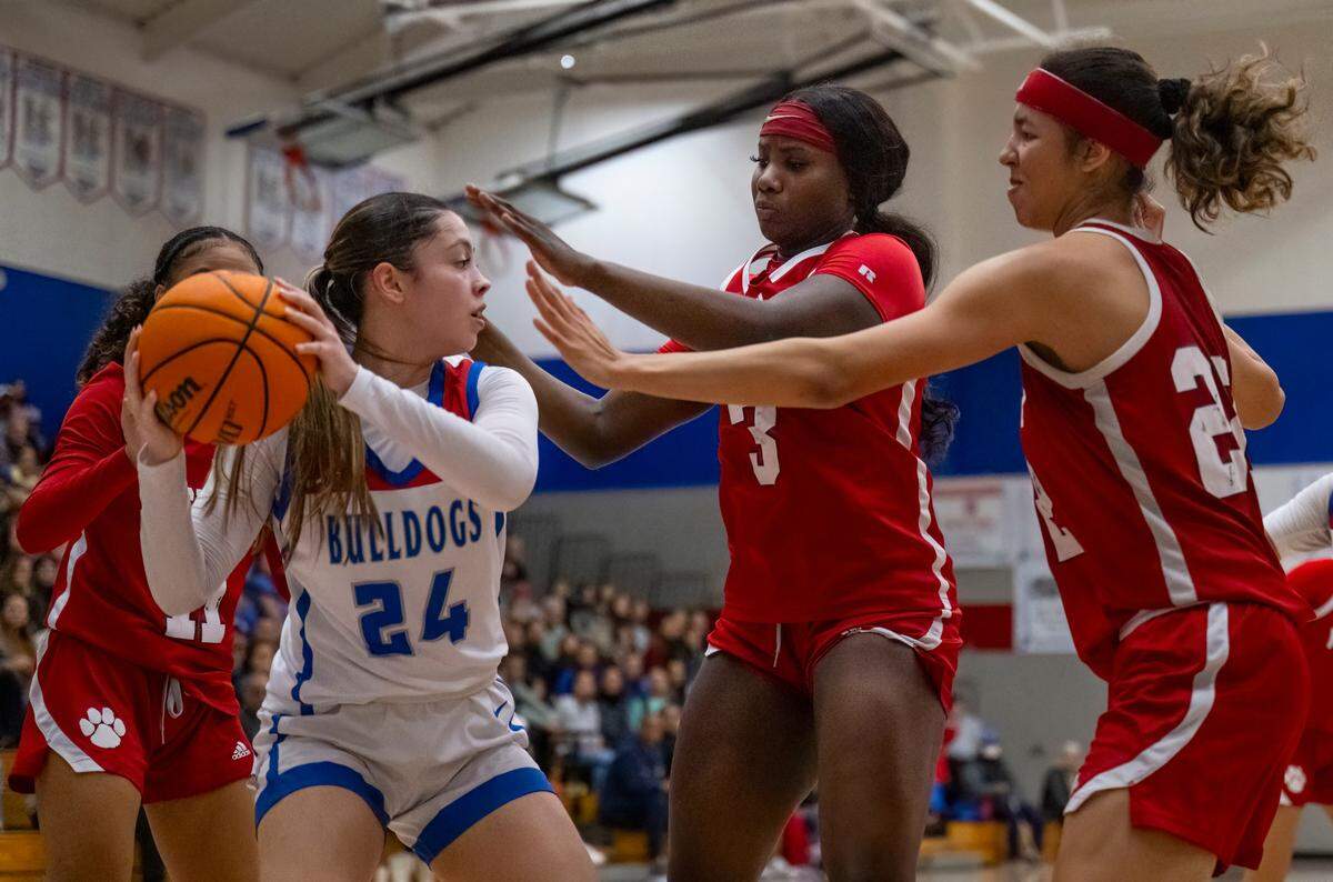 Folsom Bulldogs guard Sophia Mindermann (24) pulls down a rebound against the McClatchy Lions in the third quarter in a CIF Sac-Joaquin Section girls basketball semifinal on Monday, Feb. 19, 2024, in Folsom.