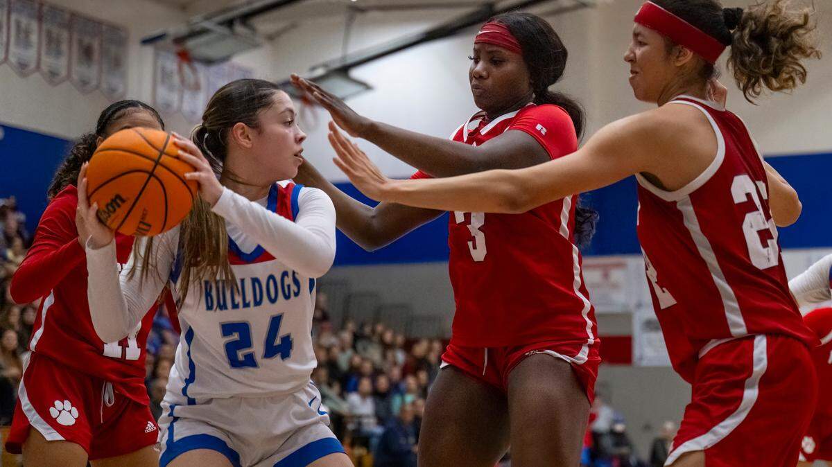 Folsom Bulldogs guard Sophia Mindermann (24) pulls down a rebound against the McClatchy Lions in the third quarter in a CIF Sac-Joaquin Section girls basketball semifinal on Monday, Feb. 19, 2024, in Folsom.