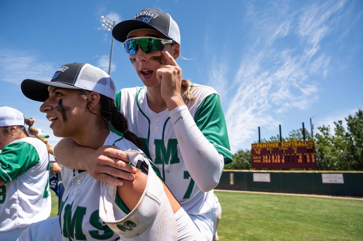 Dixon’s Brianna Humphries wipes her eye as she is carried by teammate Felesha LePenske after their 10-8 win over Marysville at the Sac-Joaquin Section Division IV title softball game Saturday, May 28, 2022, at Sacramento City College.