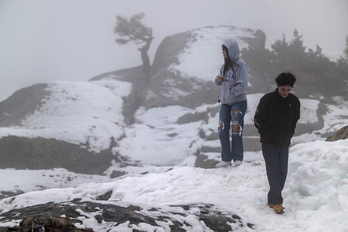 Lesly Felix, 18, of Truckee and her boyfriend Manuel Arriola, 19, of Las Vegas enjoy the sights at McGlashan Point near the Donner Summit Bridge on Old Highway 40 on Thursday.