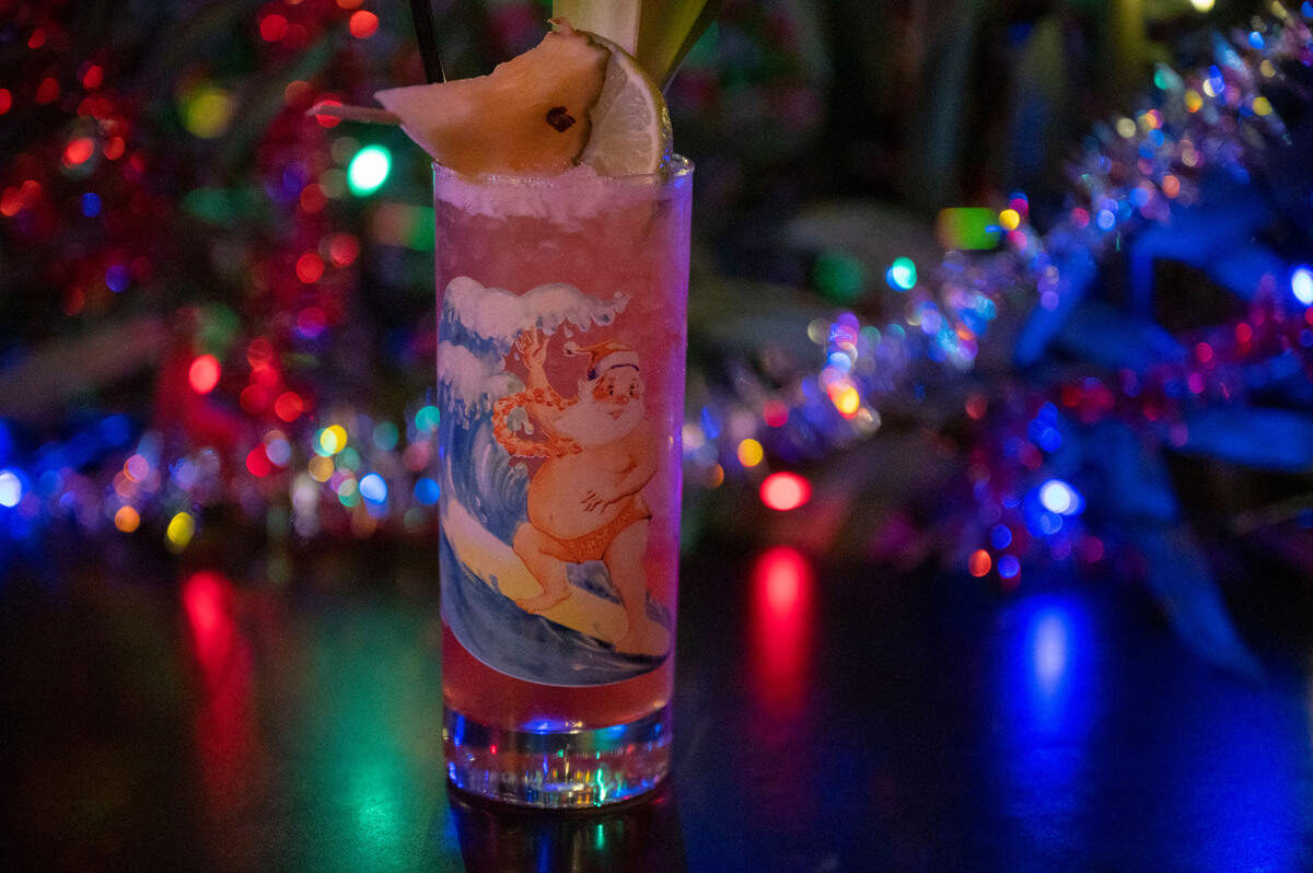 Midtown Sacramento tiki bar Jungle Bird’s holiday-themed “Jingle Bird” drink, made with bourbon, pineapple rum, Campari, and lime pineapple juices, sits on a table decorated for the holidays Tuesday.