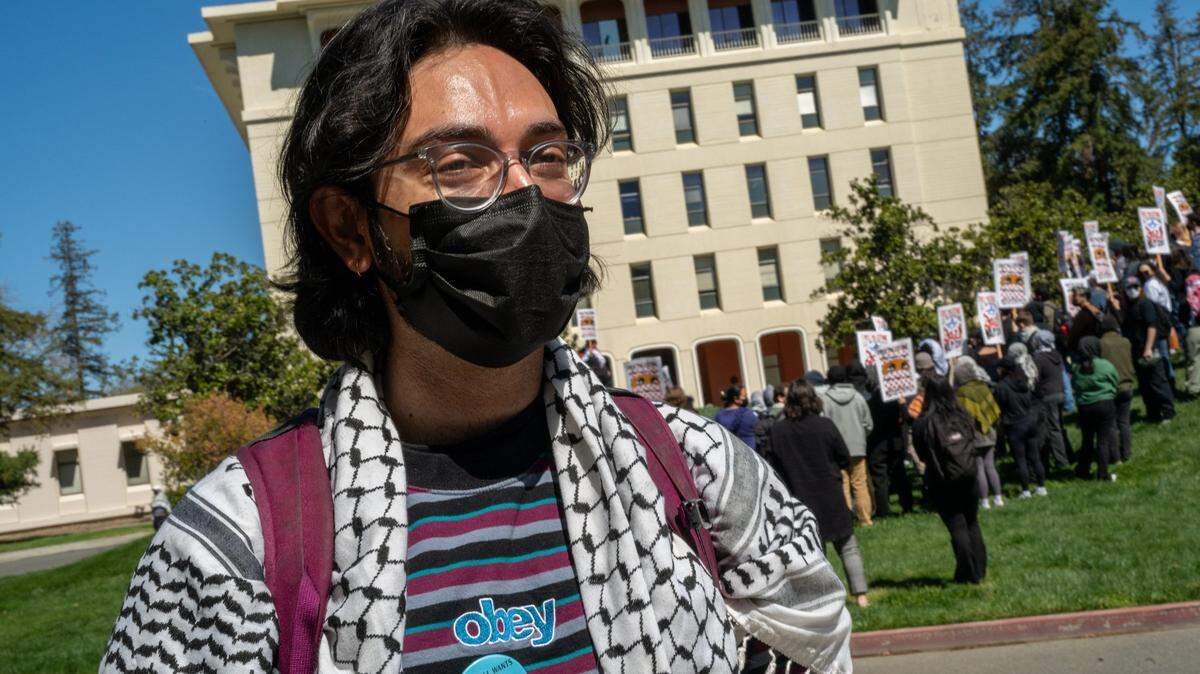 UC Davis law student Shaun Sulur stands in front of Mrak Hall with other students during a walkout on Wednesday, April 2, 2025. The group was protesting UCD’s suspension of the Law School’s student leadership organization, known as the LSA, after it resolved to boycott Israel for its actions in Gaza.