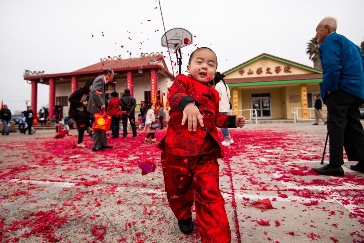 Benjamin Duong, 2, of Sacramento, throws spent firecracker paper in the air towards his father, Nam Duong, as the family celebrates the Chinese New Year during the Sacramento Chinese of Indochina Friendship Association’s annual Lunar New Year event at the temple on Elder Creek Road on Saturday, Jan. 25, 2020, in Sacramento.