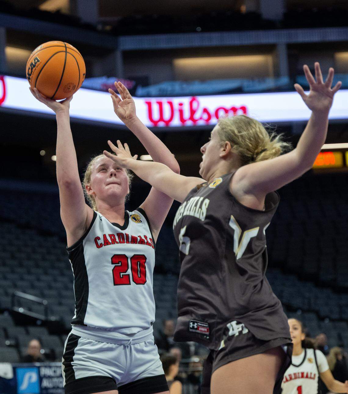 Woodland Christian's Siena Sorbello (20) is defended by Laguna Hills’ Meghan Rehmeier during the CIF State Division V girls basketball Championship at the Golden 1 Center on Friday.