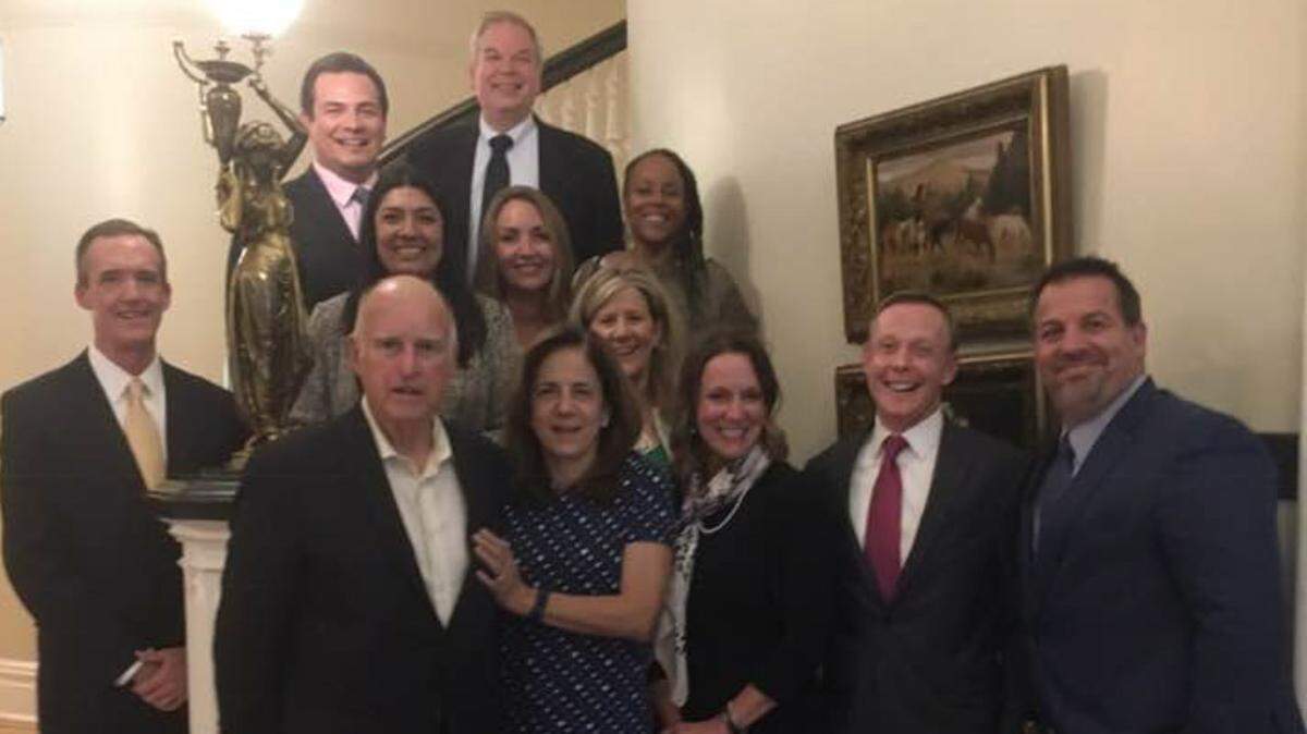 In a photo obtained by The Sacramento Bee, Gov. Jerry Brown and his wife, Anne Gust Brown, pose with representatives of Pepsi, Coca-Cola and the American Beverage Association, among other unidentified individuals, following a private dinner at the governor's mansion on June 6, 2018. The photographer is unidentified.