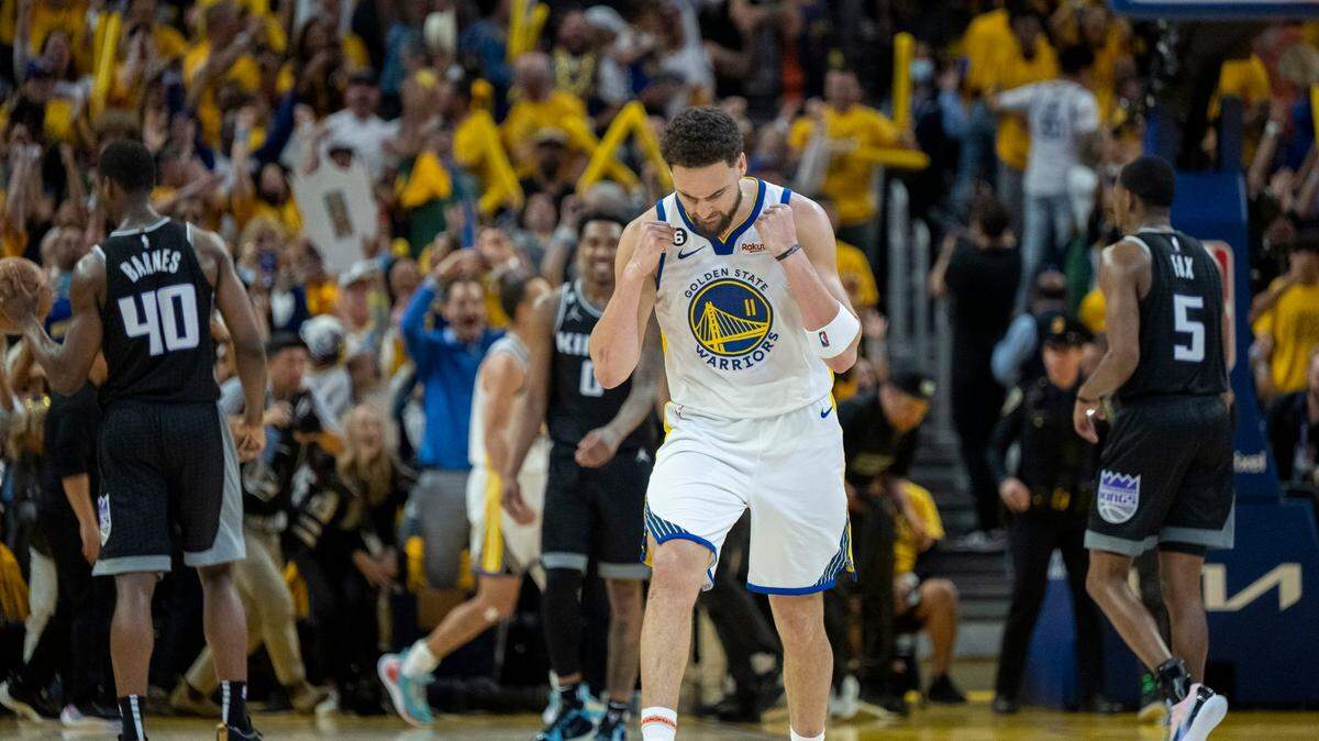 Golden State Warriors guard Klay Thompson (11) reacts after Sacramento Kings forward Harrison Barnes (40) misses his shot at the game buzzer during Game 4 on Sunday.