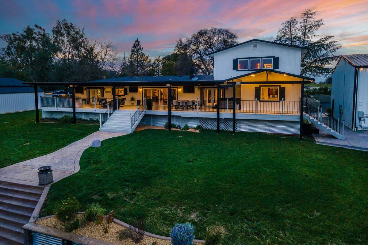 The sweeping roofed deck of the Placerville home has a well-equipped outdoor kitchen.