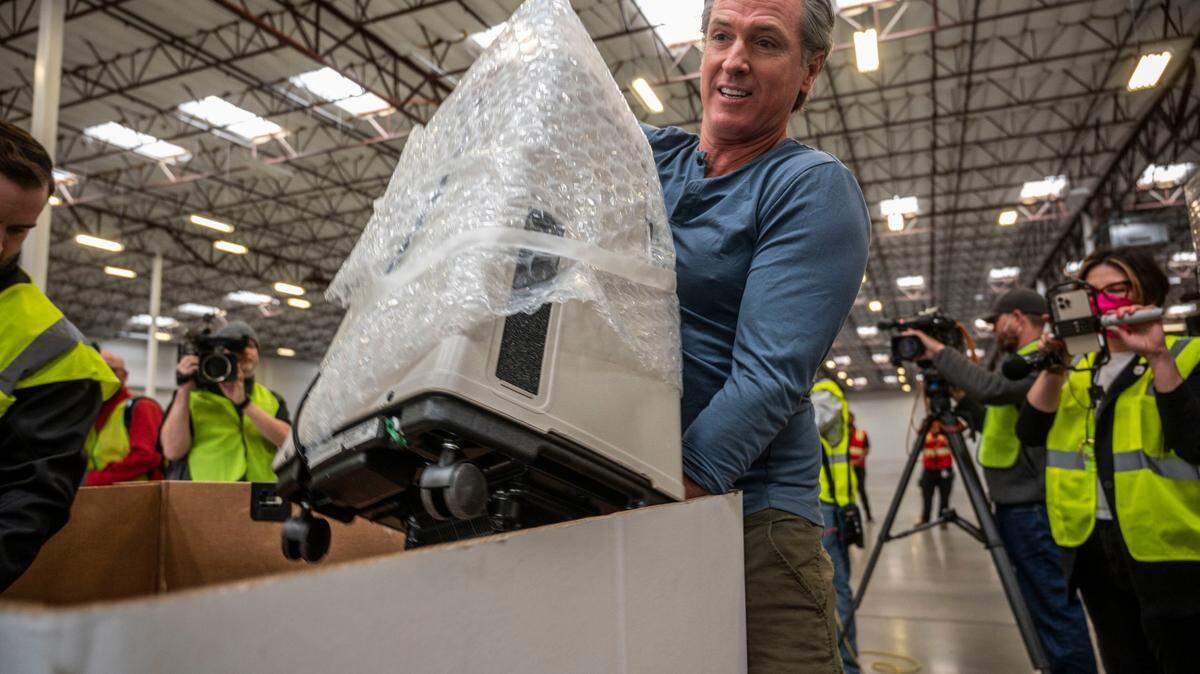 Gov. Gavin Newsom loads a ventilator and other medical supplies to be shipped to Poland for the people of Ukraine at the California Governor’s Office of Emergency Services warehouse in Dixon on Tuesday, March 15, 2022.
