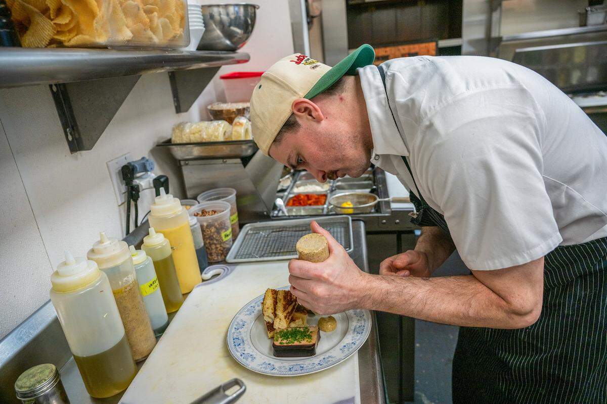 Executive Chef Galice Ryan prepares duck liver mousse with maraschino cherry gelée, toasted brioche, cornichons and Dijon in the Star Lounge kitchen last week.