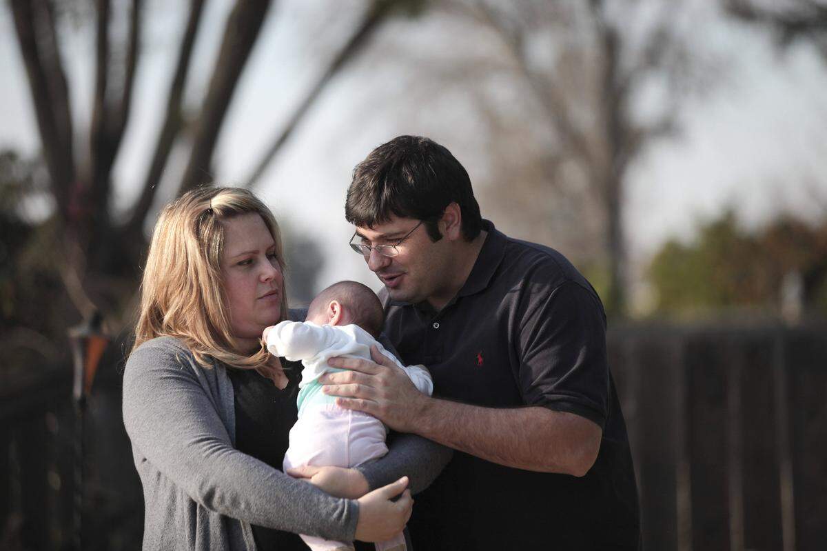 Matt Davies, right, whose multi-million dollar medical marijuana business was raided by federal and local officers, with his wife, Molly and their 10-week-old daughter, Rebecca, in Stockton, Calif., Jan. 3, 2013. Davies, a 34-year-old father of two, now faces years in prison in a case that highlights the growing clash between the Federal government and states that have legalized marijuana for medical or recreational use. (Jim Wilson/The New York Times)