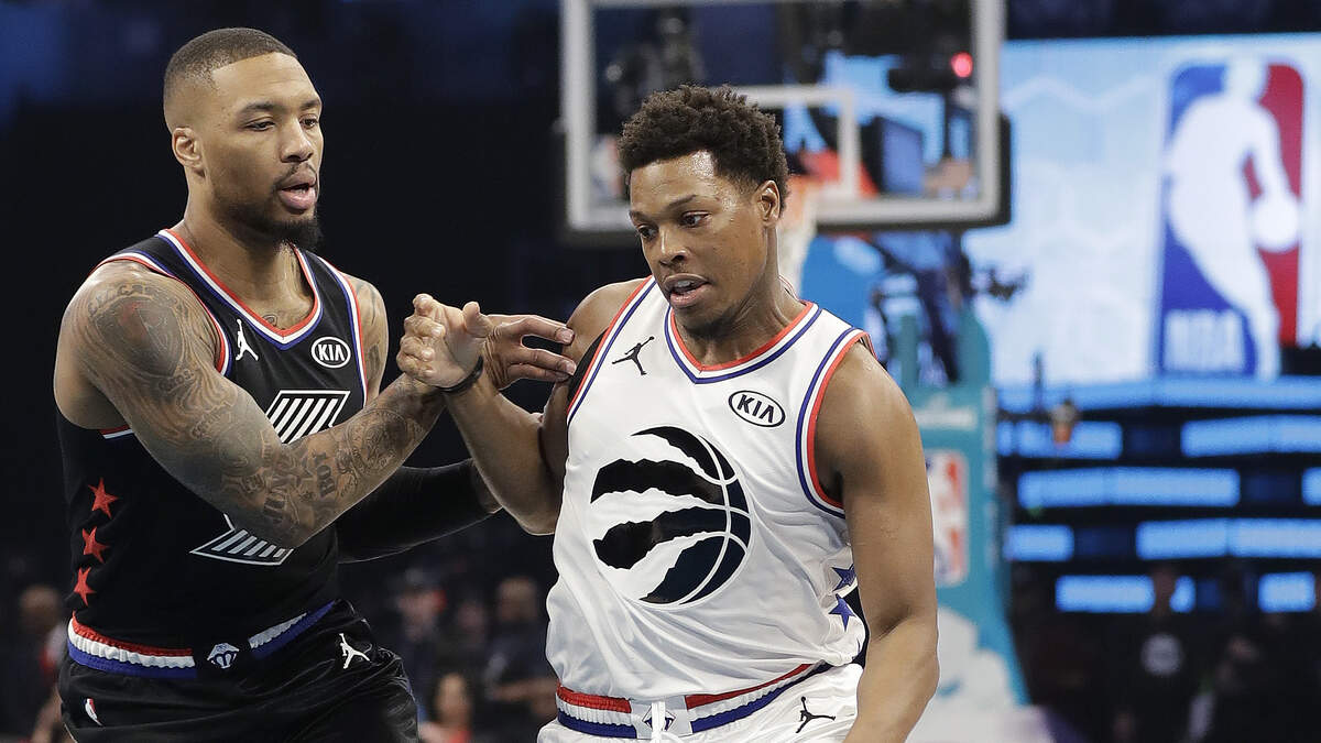 Team Giannis’ Kyle Lowry, of the of the Toronto Raptors, moves past Team LeBron’s Damian Lillard, of the Portland Trail Blazers during the first half of an NBA All-Star basketball game, Sunday, Feb. 17, 2019, in Charlotte, N.C. (AP Photo/Chuck Burton)
