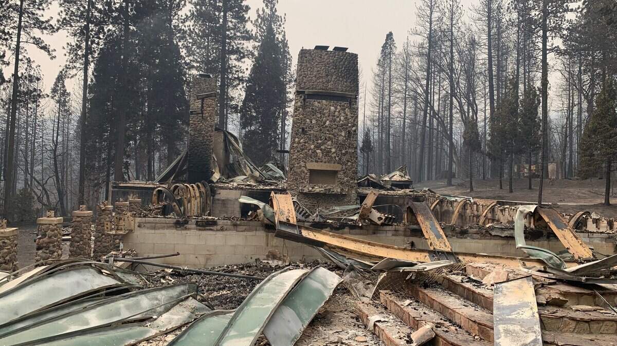 Two chimneys stand at Camp Okizu on Thursday, Sept. 10, 2020, after the summer camp for children with cancer and their families was burned by the Bear Fire.