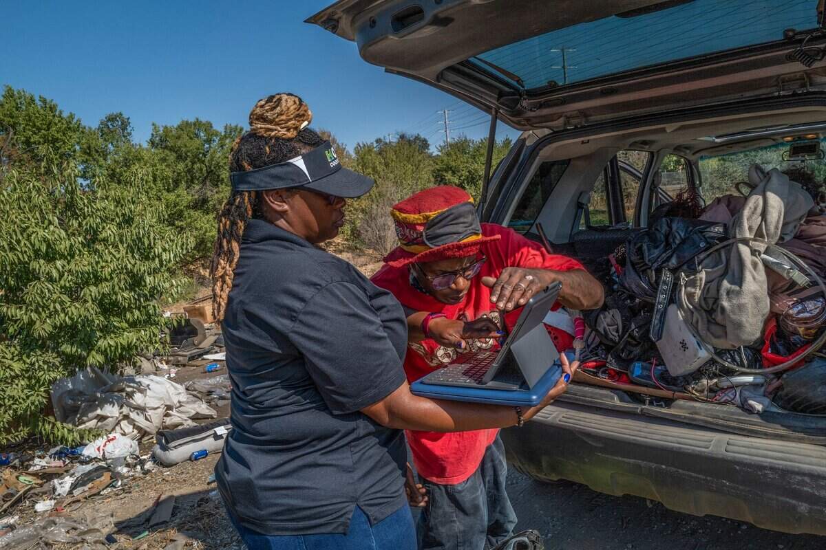 C.K. Bailey, 40, confirms the information that Alanna McWilliams, a team lead outreach navigator for Hope Cooperative, has stored about him in her computer on Thursday. He was surprised that his information dated to 2017. That’s how long I’ve been out here, said Bailey, who lives in the “snake pit” homeless encampment. Bailey refused help at first and only wanted money but later changed his mind when he was told he might be able to get a gas card.