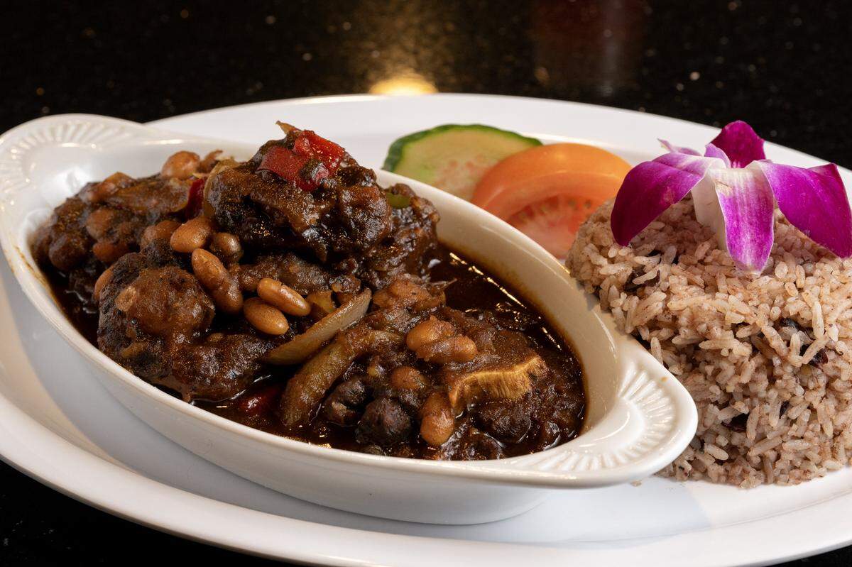 Oxtails and butter beans with a side of Jamaican rice and peas served at Calabash Caribbean in Sacramento on Friday.