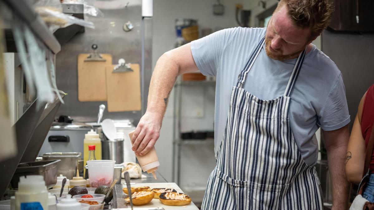 Matt Brown works to finish a tripleta — a sandwich with grilled chicken, bacon and a slow-roasted pork called pernil — at Bodega Kitchen & Cocktails on Aug. 4, 2022, in Sacramento’s Greenhaven neighborhood. Brown plans to open Husick’s by Forester, a bistro and Sacramento-San Joaquin Delta wine bar, in August 2024 in Clarksburg.