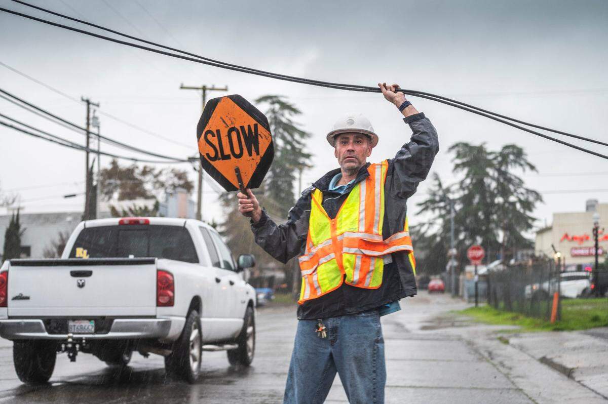 Jeff Kofoid with AT&T holds downed telecommunications lines on Monday, Dec. 13, 2021 on M Street Rio Linda as high winds and rain created hazardous situations in the region.