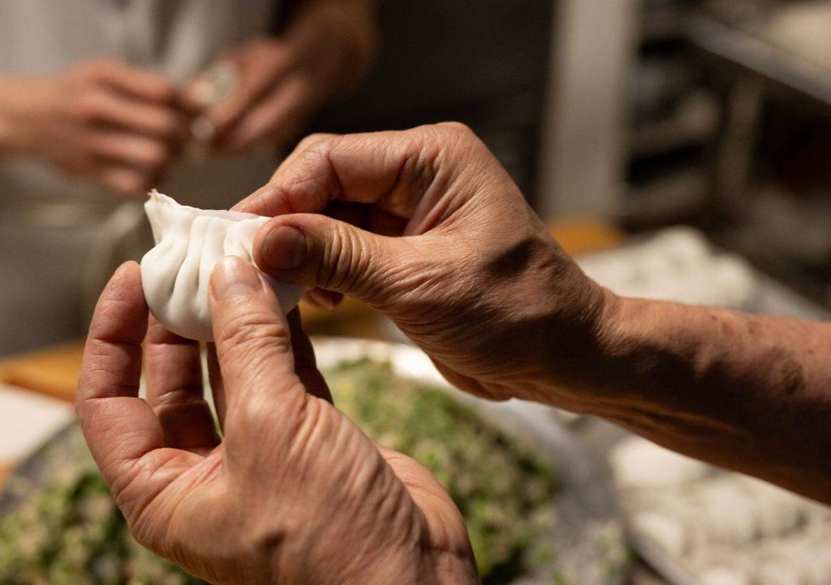 Owner Yao Li and his staff make dim sum filled with chives, chicken and shrimp at Lam Kwong Deli & Market on March 20.