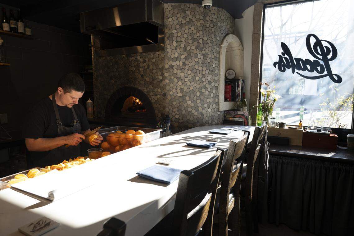 A member of the Localis kitchen staff supremes and peels oranges for the second course of brunch on Sunday, Feb. 22, 2026. 