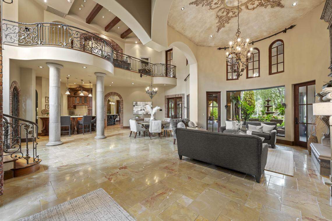 Dramatic archways, soaring ceilings, and Botticelli-inspired art greet you in the grand living room.