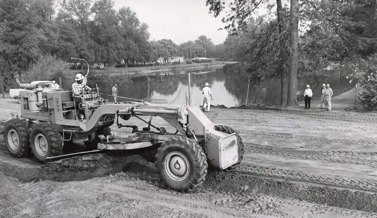 A grader helps fill in a portion of Southside Park’s lake  in 1965 as part of the W-X freeway project, which extended W Street through the Sacramento park. The state lopped off about 7 acres of the park to build Highway 50.