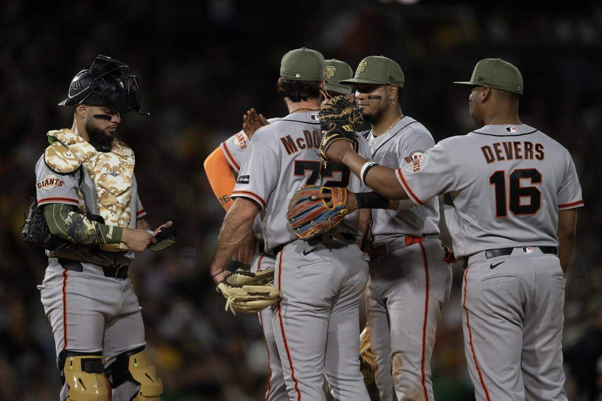San Francisco Giants pitcher Trevor McDonald is congratulated by his teammates after being removed the game after pitching 6 2/3 innings Saturday against the Athletics at Sutter Health Park in West Sacramento.