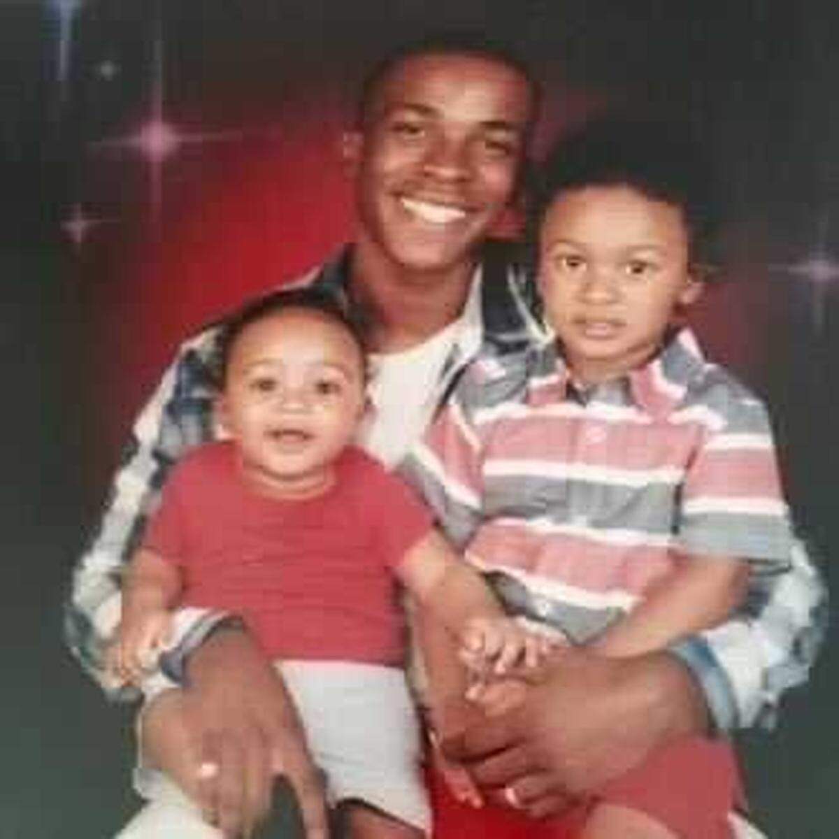 In this undated photo, Stephon Clark clutches his children, Cairo Clark, left, and Aiden Clark. Clark’s family recalled his loving smile on the anniversary of his death and how this picture showed how much he loved his children.