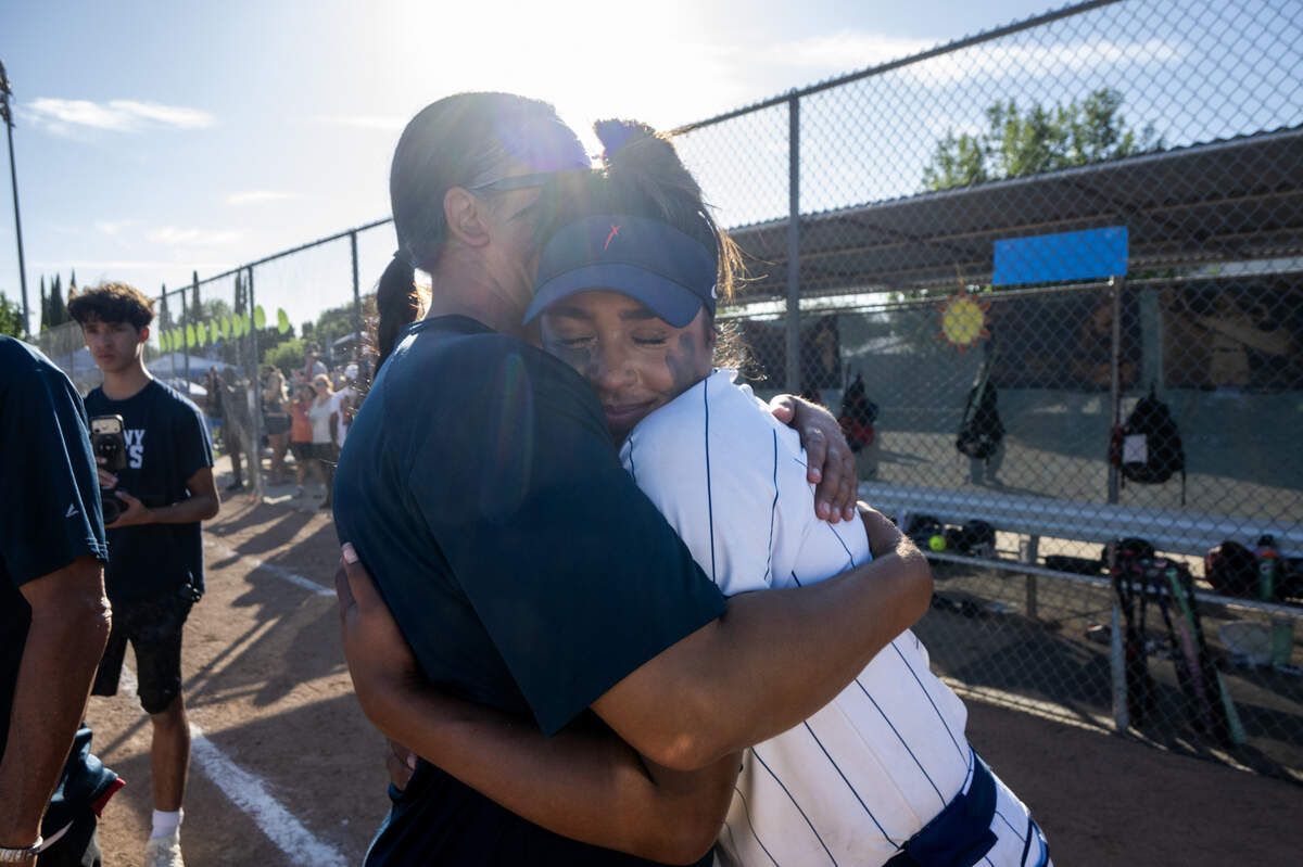 The Destiny Christian Academy Lions’ Ayla Tuua is embraced by her mother, coach Shannon Tuua, following the 6-3 victory to capture the CIF NorCal Division I softball championship against the Whitney Wildcats on Saturday, June 6, in Rancho Cordova. Destiny Christian finished with a perfect 31-0 season.