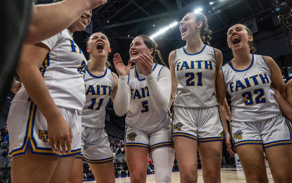 The Faith Christian Lions’ Mia Bryan (11), Lauren Harris (5), Presley Berry (21) and Esther Borlean (32) celebrate their victory against Sacramento Adventist during a CIF Sac-Joaquin Section Division VI girls basketball championship game at Golden 1 Center on Thursday, Feb. 27, 2025.