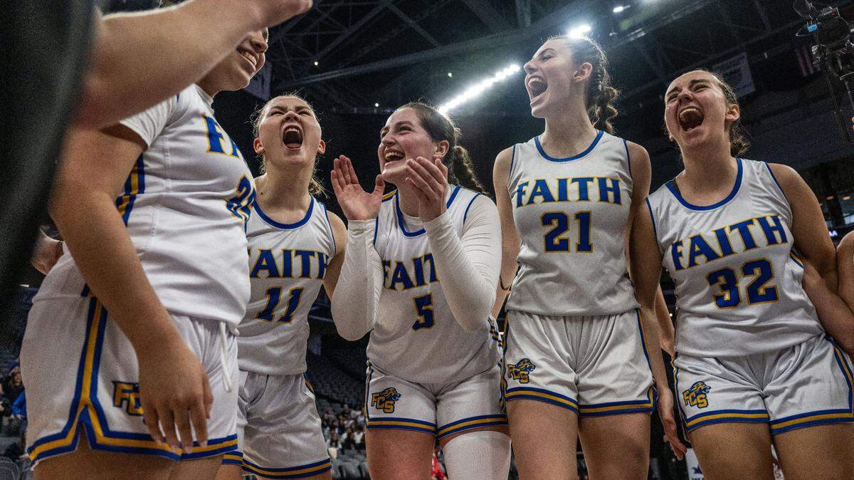 The Faith Christian Lions’ Mia Bryan (11), Lauren Harris (5), Presley Berry (21) and Esther Borlean (32) celebrate their victory against Sacramento Adventist during a CIF Sac-Joaquin Section Division VI girls basketball championship game at Golden 1 Center on Thursday.