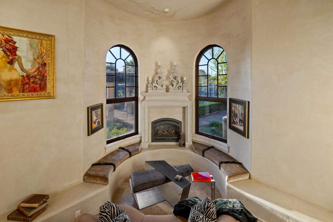 The seller’s favorite room is a circular sunken conversation pit with a fireplace and a water feature.