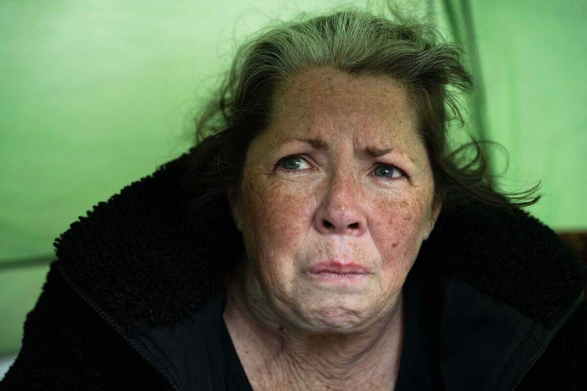Ginger Gibbons, 56, sits in her tent in Sacramento on Thursday. Gibbons said she is disabled and has been homeless for seven years. Before she was taken to the Sacramento jail, she lived near near a light rail station with a close-knit group of friends. “I actually want to die right now, they destroyed me,” said Gibbons as her eyes welled with tears.
