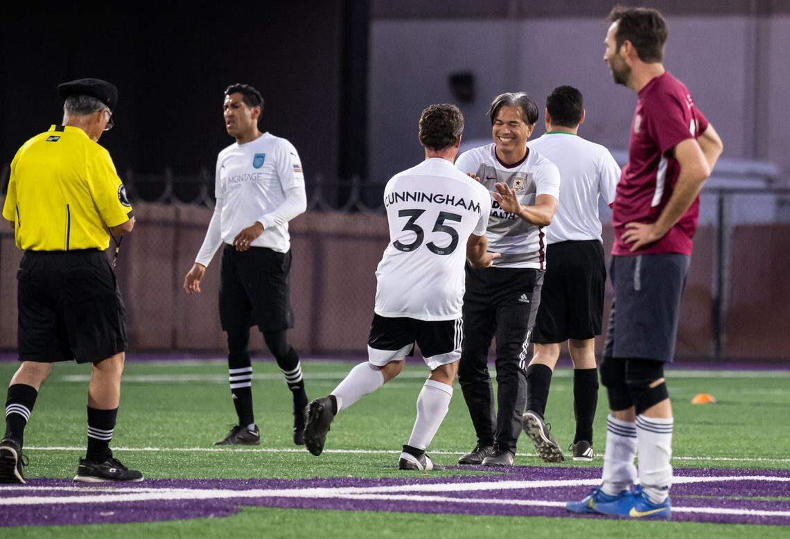 California Attorney General Rob Bonta, right, is congratulated on his goal by Northern California teammate Assemblyman Jordan Cunningham, R-San Luis Obispo, as they play state legislators from Southern California in the fifth annual Capitol Cup charity soccer game Wednesday at Cristo Rey High School in Sacramento. Northern California beat Southern California 5-2.