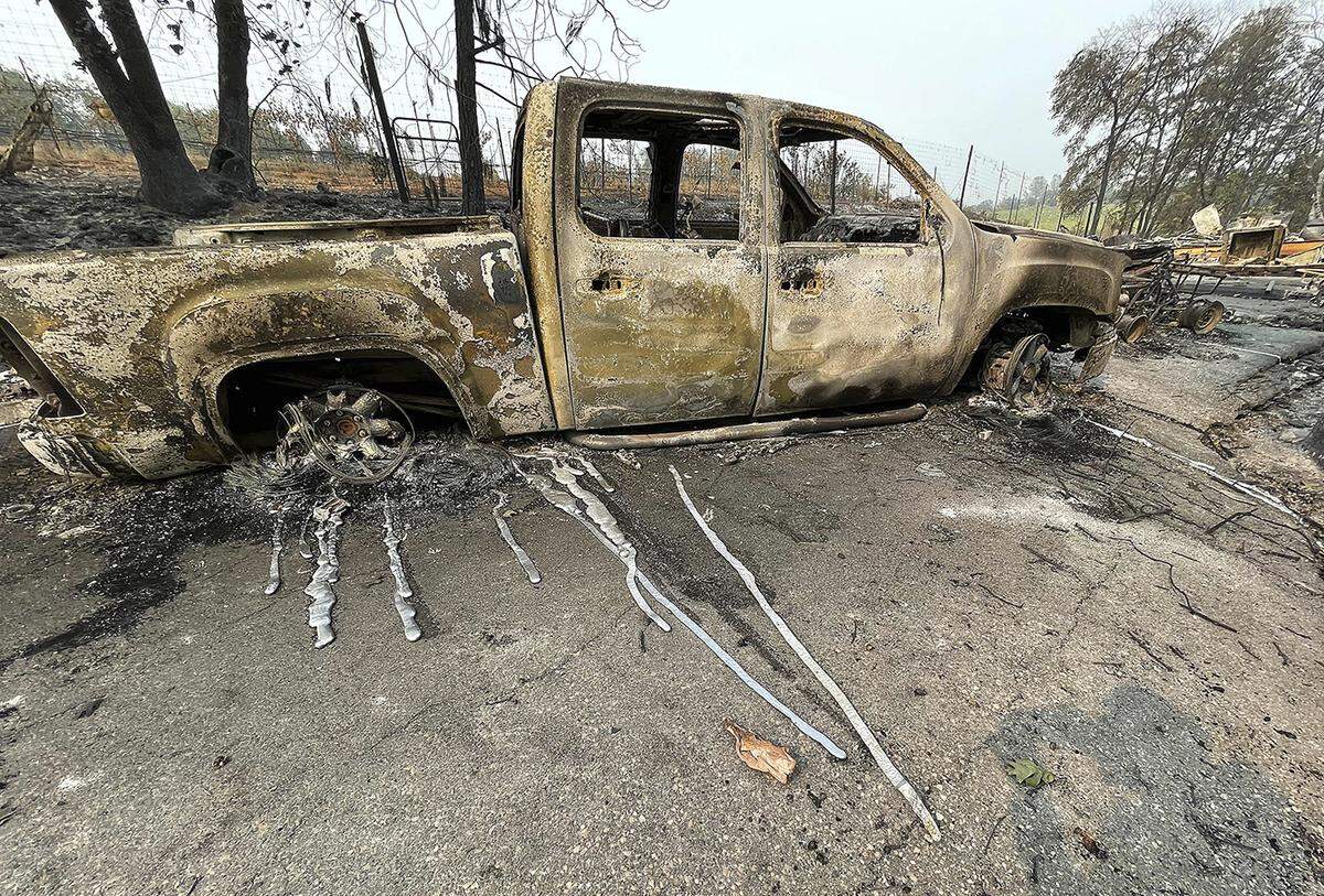 The melted metal from a pickup truck’s rims ran down the driveway of this Chicago Park home after the River Fire burned through here Saturday, Aug. 7, 2021. The fire broke out Wednesday near the town of Colfax and destroyed 68 homes and other buildings..