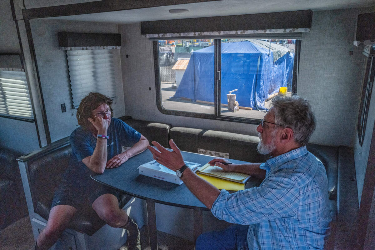 Sharon Jones, left, one of the founders of Camp Resolution, strategizes inside a newly delivered travel trailer with Anthony Prince, right, the attorney for the California Homeless Union who represented the residents of Camp Resolution in negotiations with the city, in North Sacramento on Monday. The trailer, the first of dozens expected, will be used for administrative purposes for the residents of the homeless encampment.