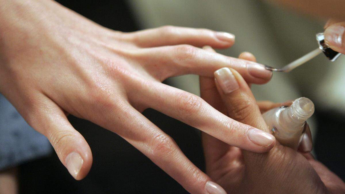 A model gets finger nail polish before the Vera Wang 2008 spring collection is modeled during Fashion Week in New York.