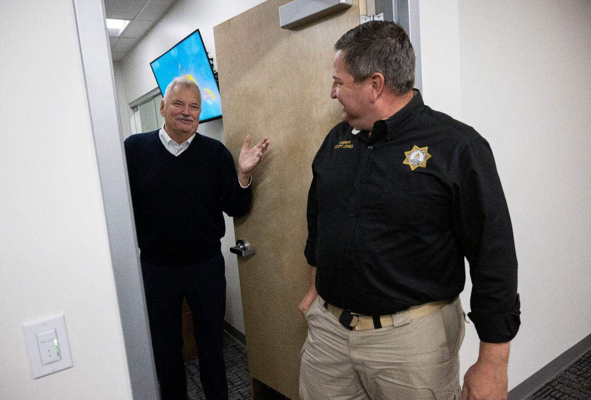 Former Sacramento County Sheriff John McGinness, left, visits Sheriff Scott Jones for a barbecue in November celebrating his successor’s time in office.