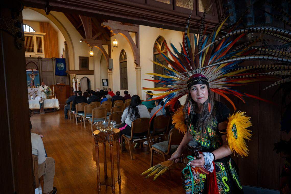 Sonia Martinez, a dancer with Danza Azteca Huitzitzilin Ollin, prepares to dance for the congregation of Iglesia Luterana Santa María Peregrina in Stockton. Its pastor is outspoken about his support for immigrants.