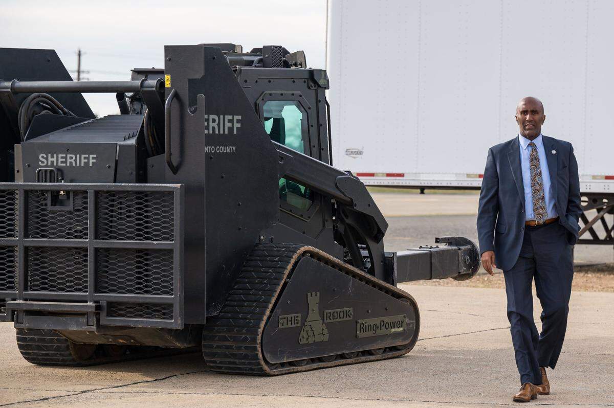 Sacramento County Sheriff Jim Cooper walks past the department’s Rook - configured with an hydraulic breaching ram attachment on the front - on Thursday before SWAT team members demonstrated the vehicle at their facility in Sacramento County.