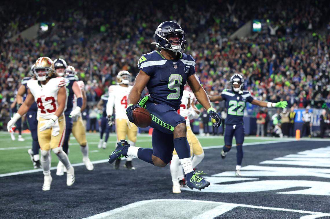 Kenneth Walker III of the Seattle Seahawks scores a touchdown during the fourth quarter against the San Francisco 49ers in an NFC divisional round playoff game at Lumen Field on Saturday in Seattle.